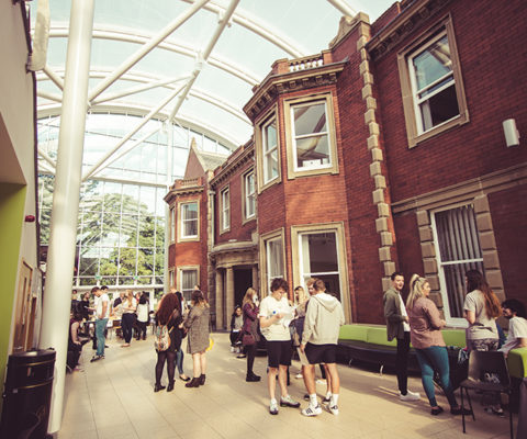Wide interior shot of Hartlepool Sixth Form Campus, showcasing several students talking with one another