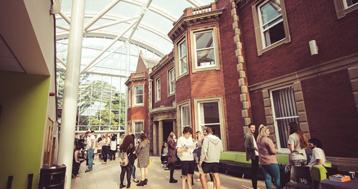 Wide interior shot of Hartlepool Sixth Form Campus, showcasing several students talking with one another