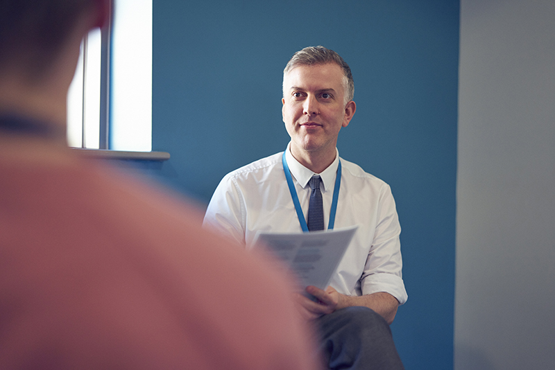 A male counselor providing one-on-one support to a student in an office at Hartlepool Sixth Form.