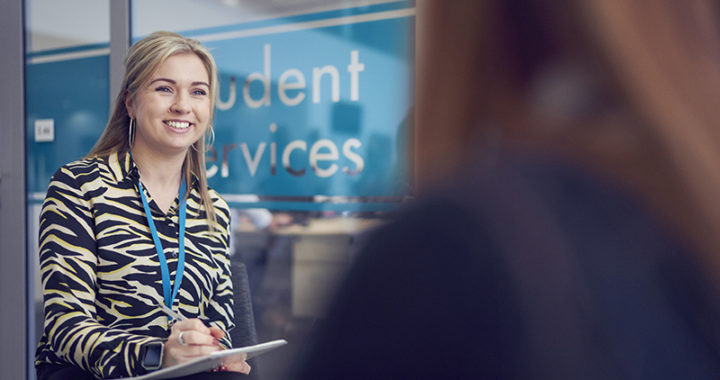 A student support counselor providing one-on-one support to a student in an office at Hartlepool Sixth Form.